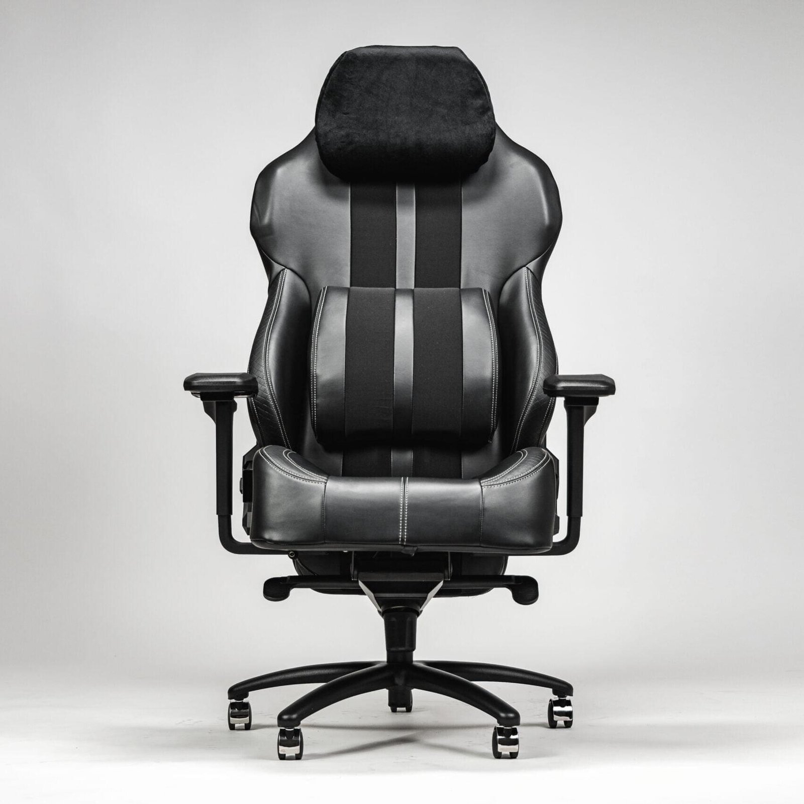 Modern black leather office chair with a supportive black leather backrest, equipped with a cordless massage feature for comfort.